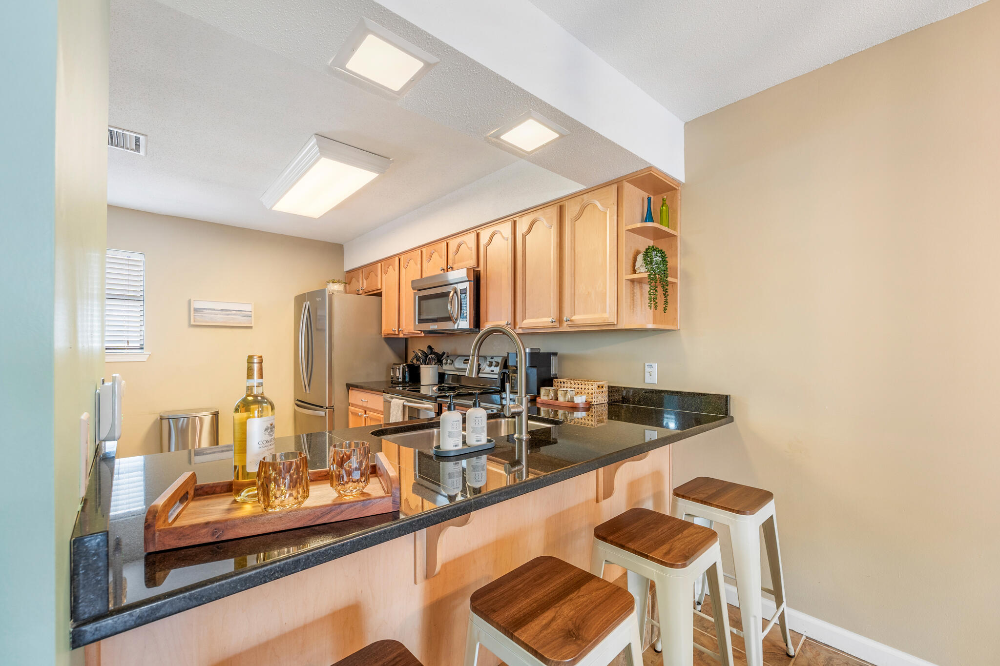 11 Driftwood Road, Unit 2 Miramar Beach, FL 32550 - Photo 12 of 45 a kitchen with granite countertop sink and cabinets