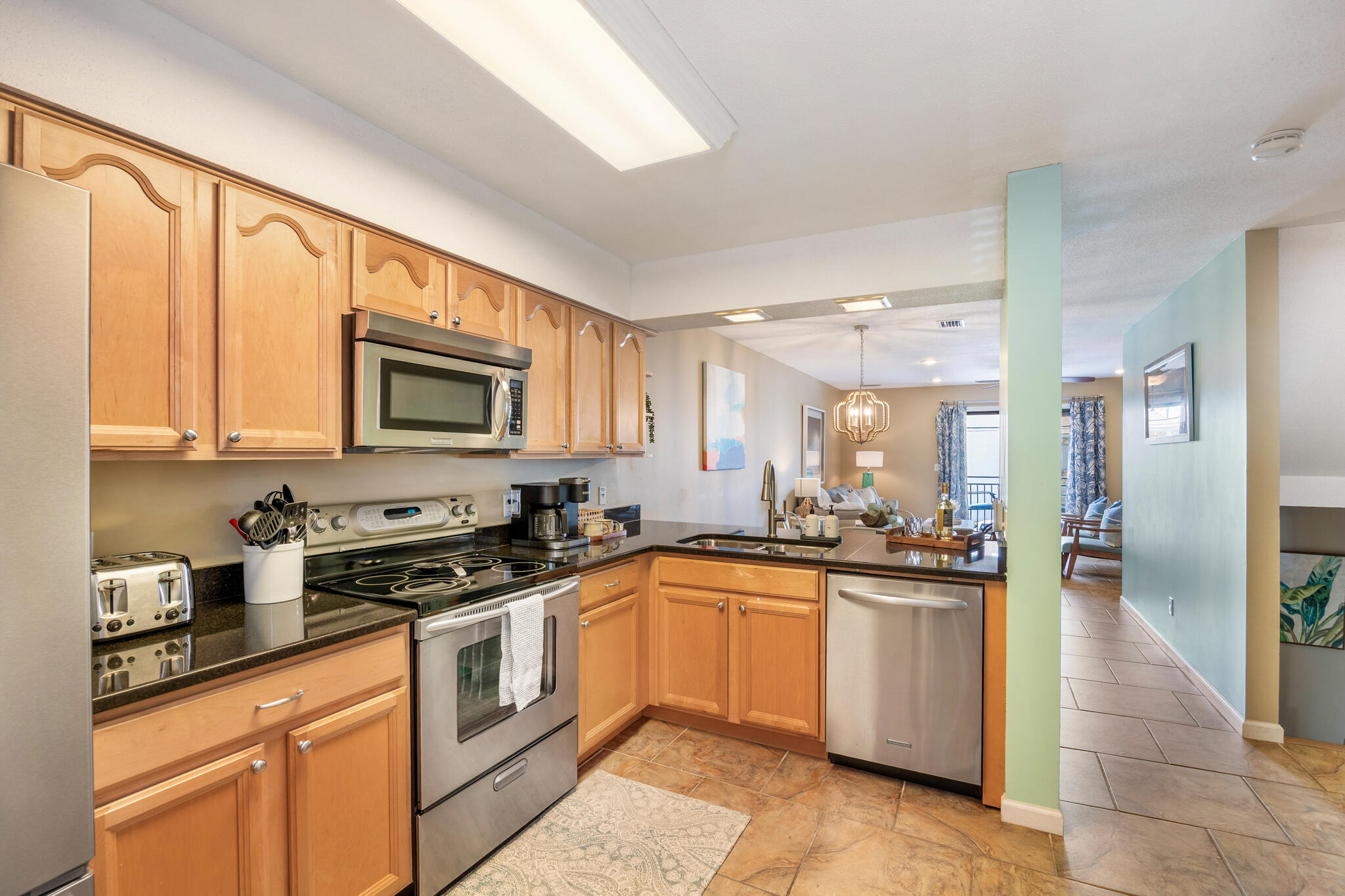11 Driftwood Road, Unit 2 Miramar Beach, FL 32550 - Photo 14 of 45 a kitchen with granite countertop a sink a counter top space stainless steel appliances and cabinets