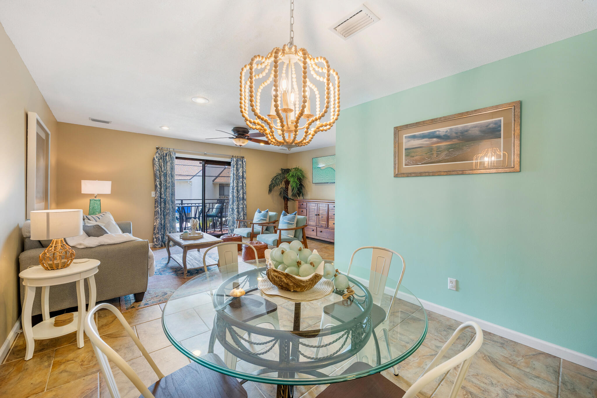11 Driftwood Road, Unit 2 Miramar Beach, FL 32550 - Photo 16 of 45 a living room with furniture a table and a chandelier