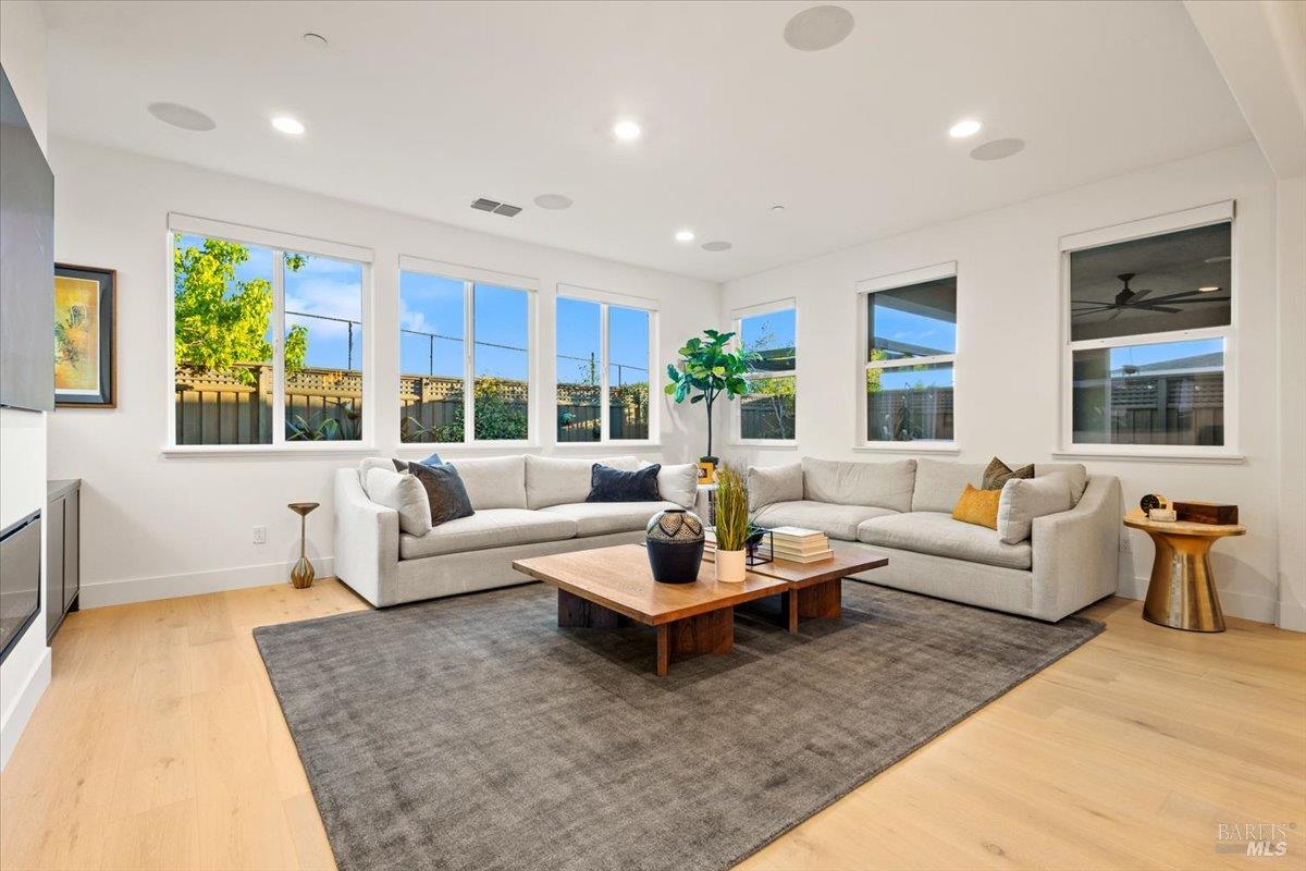 1469 Oak Circle Rohnert Park, CA 94928 - Photo 13 of 42 Filled with Natural Light Expansive windows surround the main living area, creating a bright and inviting space while offering beautiful views of the backyard and outdoor entertaining areas.