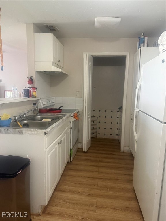 3207 Broadway Fort Myers, FL 33901 - Photo 23 of 25 a kitchen with stainless steel appliances a refrigerator sink and cabinets