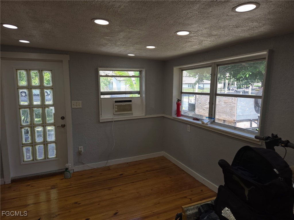 3207 Broadway Fort Myers, FL 33901 - Photo 4 of 25 a view of an empty room with wooden floor and a window