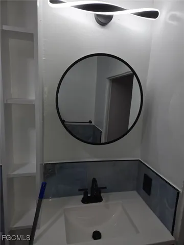 a bathroom with a sink and mirror
