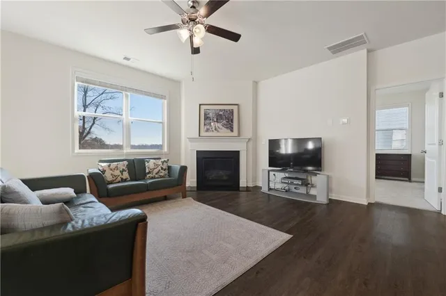 a living room with furniture a fireplace and a flat screen tv