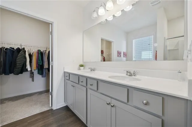 a bathroom with a sink double vanity and a mirror