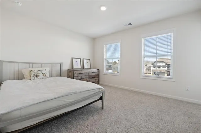 a bedroom with a bed lamp and window