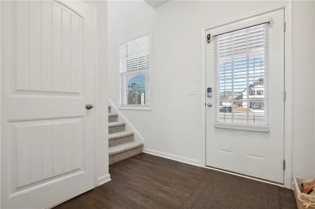 a view of an entryway with wooden floor