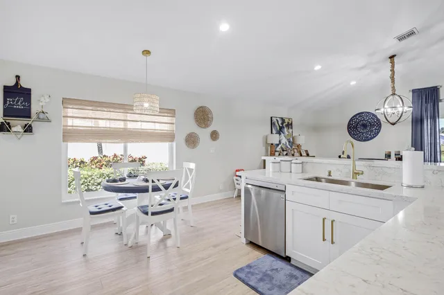 a kitchen with stainless steel appliances granite countertop a sink and cabinets