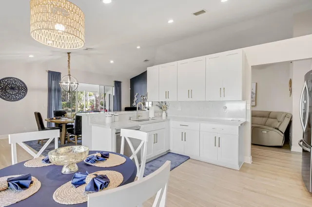 a kitchen with a sink stainless steel appliances and white cabinets