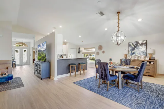 a view of a dining room with furniture wooden floor and chandelier