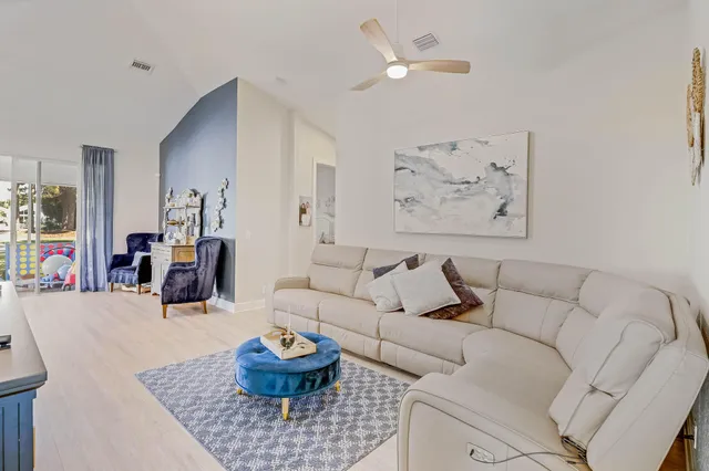 a living room with furniture and painting on the wall