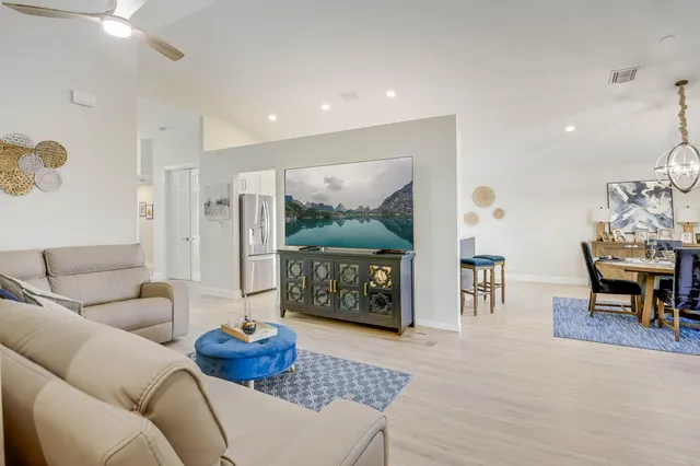 a bedroom with a large bed and ceiling fan