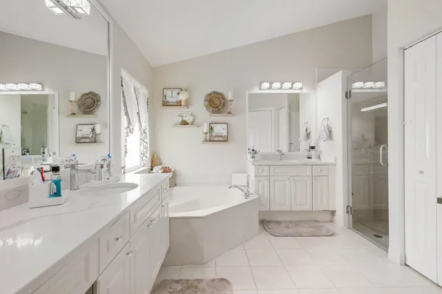 a bathroom with a bathtub sink and mirror