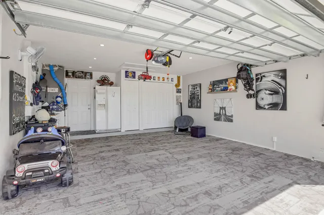 a living room with large windows and a table