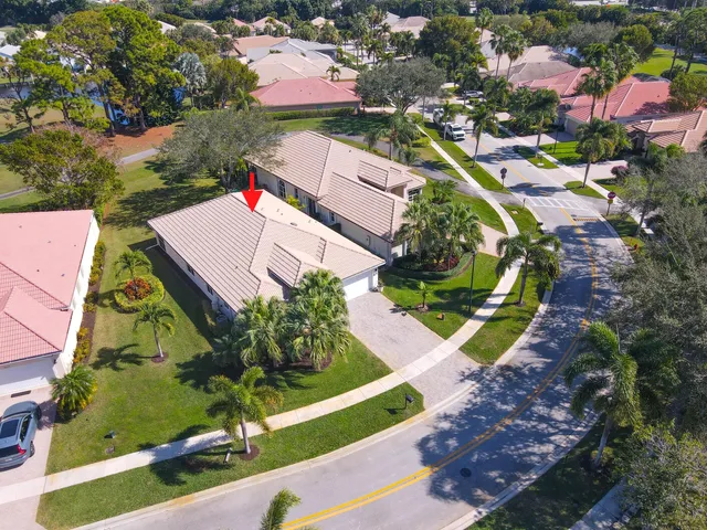 an aerial view of residential houses with outdoor space and lake view