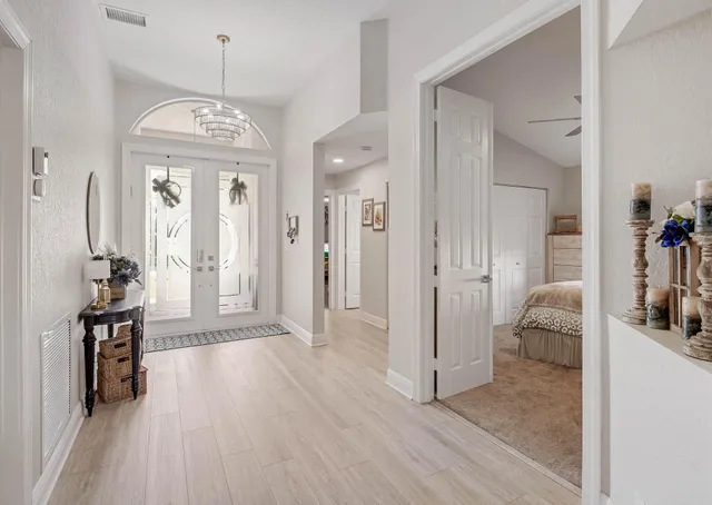 a view of a livingroom with a furniture wooden floor and a chandelier