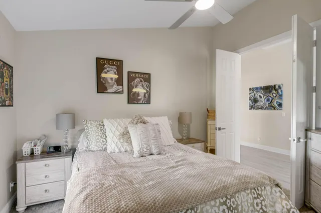 a bedroom with a large bed and a chandelier