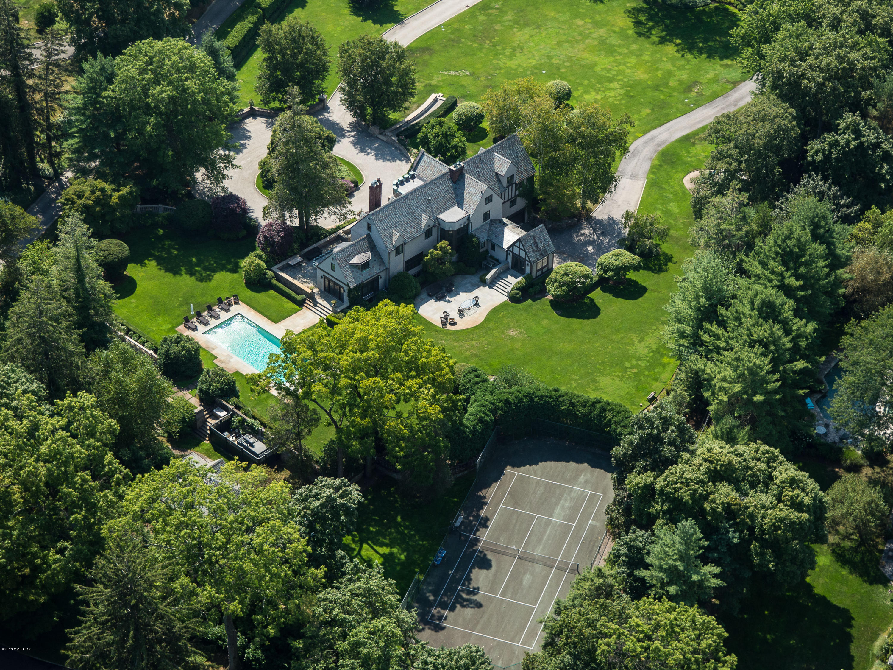 an aerial view of a house with a yard and lake view