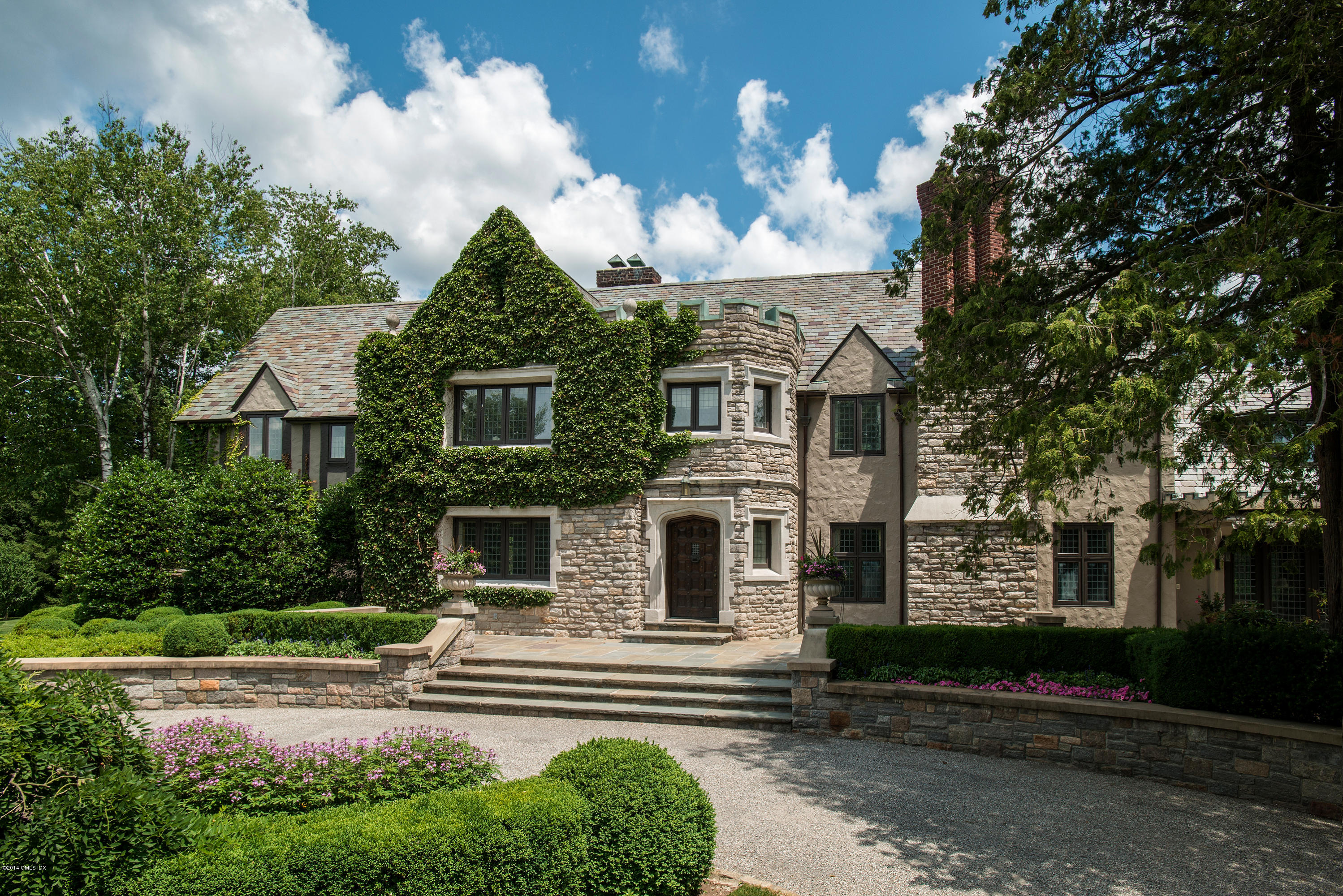 11 Flagler Drive Greenwich, CT 06830 - Photo 3 of 19 a front view of a house with a garden and trees
