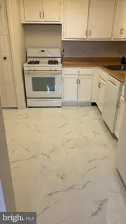 a kitchen with a stove top oven and cabinets