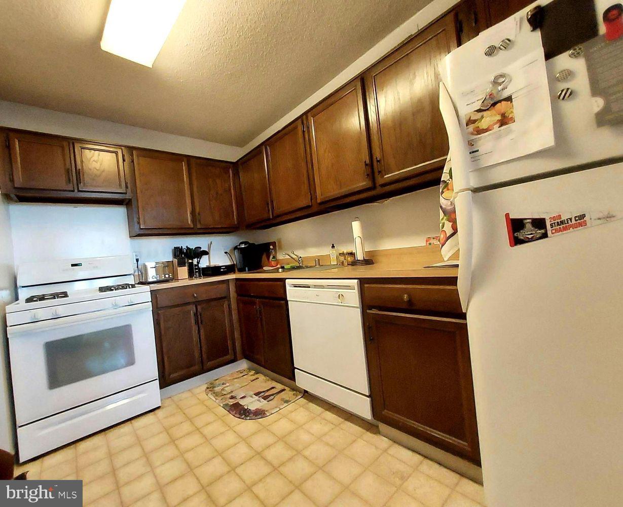 5225 Pooks Hill Road, Unit 1211S Bethesda, MD 20814 - Photo 21 of 36 a kitchen with a stove top oven and cabinets