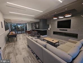 5225 Pooks Hill Road, Unit 1211S Bethesda, MD 20814 - Photo 27 of 36 a living room with furniture and a flat screen tv