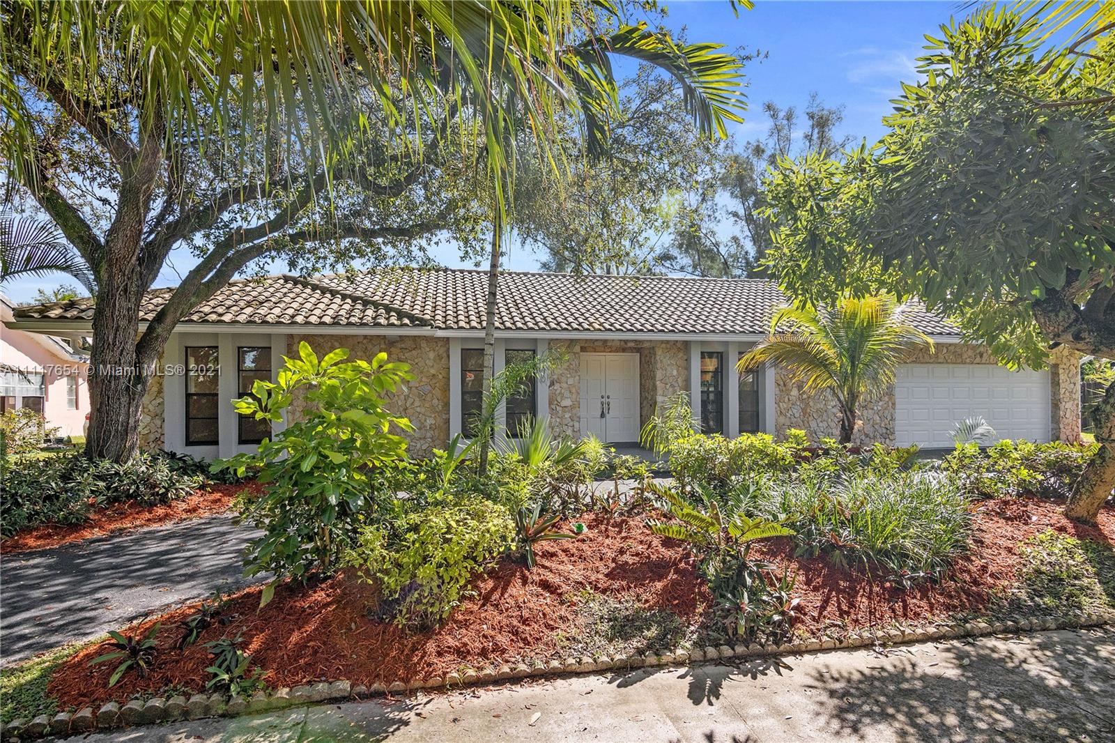 a front view of a house with garden