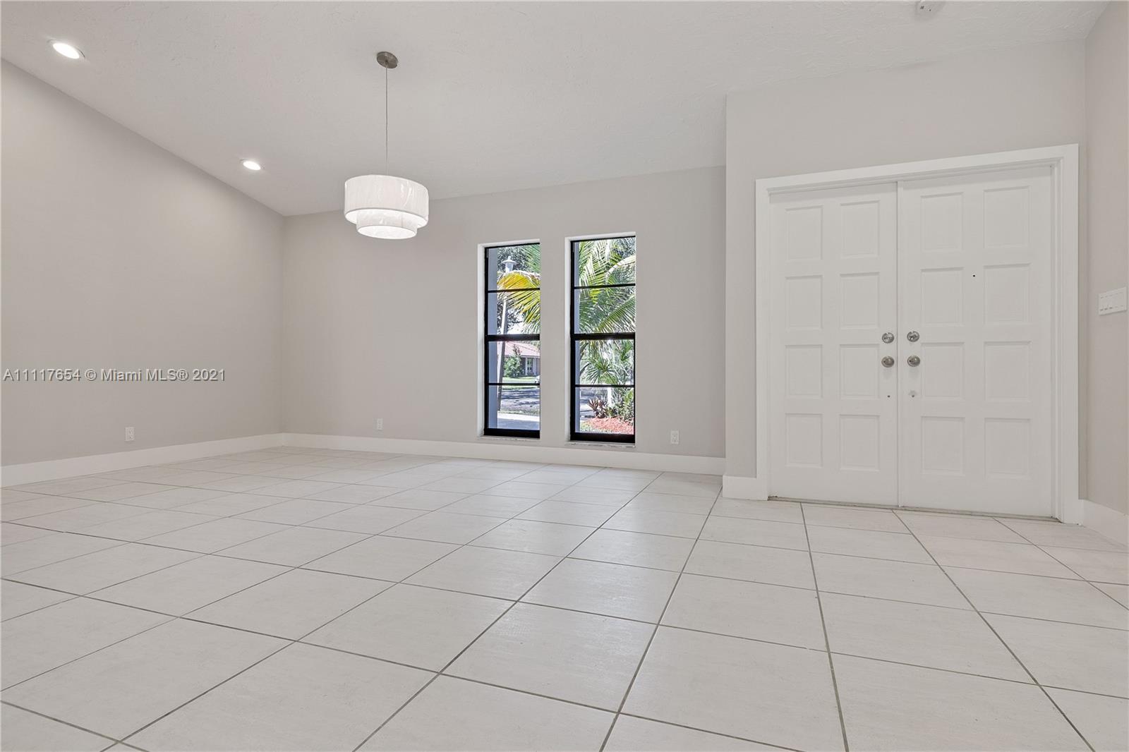 1960 Southwest 51st Terrace Plantation, FL 33317 - Photo 11 of 35 an empty room with windows and ceiling fan