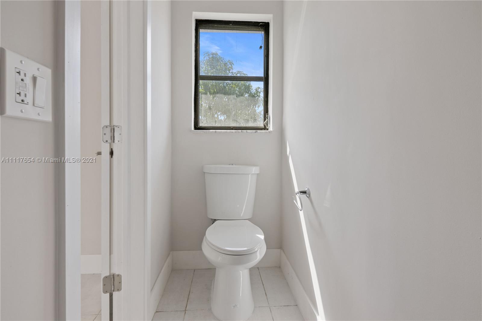 1960 Southwest 51st Terrace Plantation, FL 33317 - Photo 18 of 35 a white toilet sitting next to a small bathroom