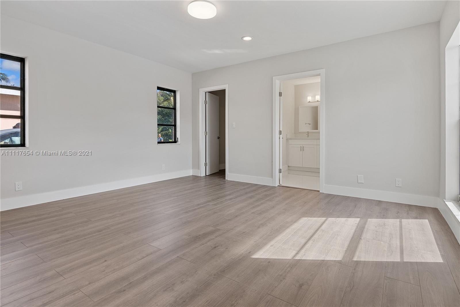 1960 Southwest 51st Terrace Plantation, FL 33317 - Photo 20 of 35 an empty room with wooden floor and windows