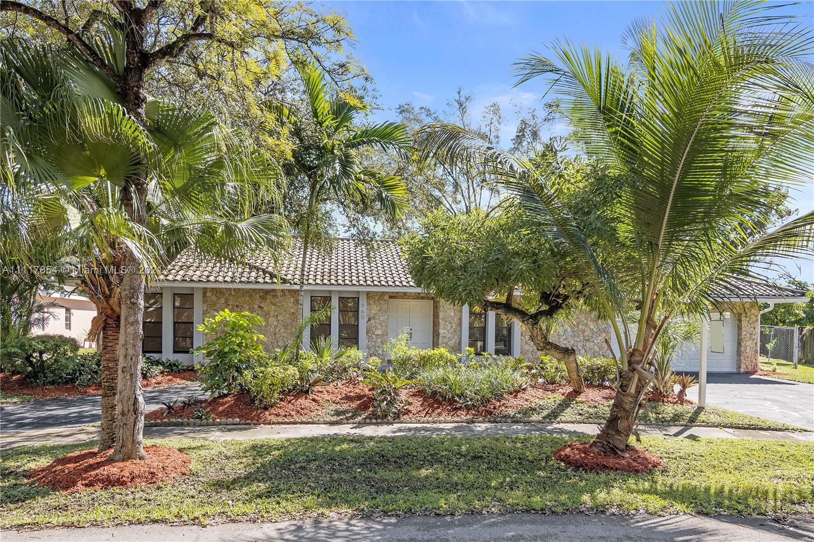 1960 Southwest 51st Terrace Plantation, FL 33317 - Photo 2 of 35 a front view of a house with garden