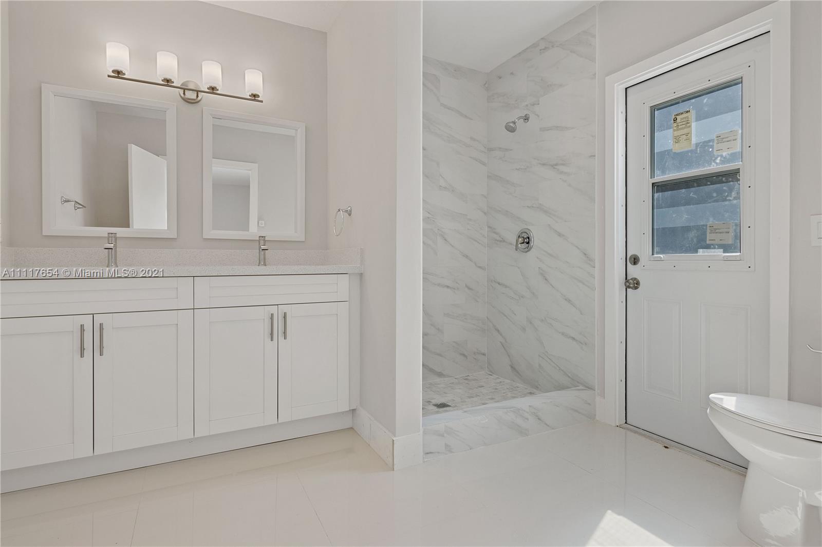 1960 Southwest 51st Terrace Plantation, FL 33317 - Photo 21 of 35 a spacious bathroom with a granite countertop sink a toilet and shower