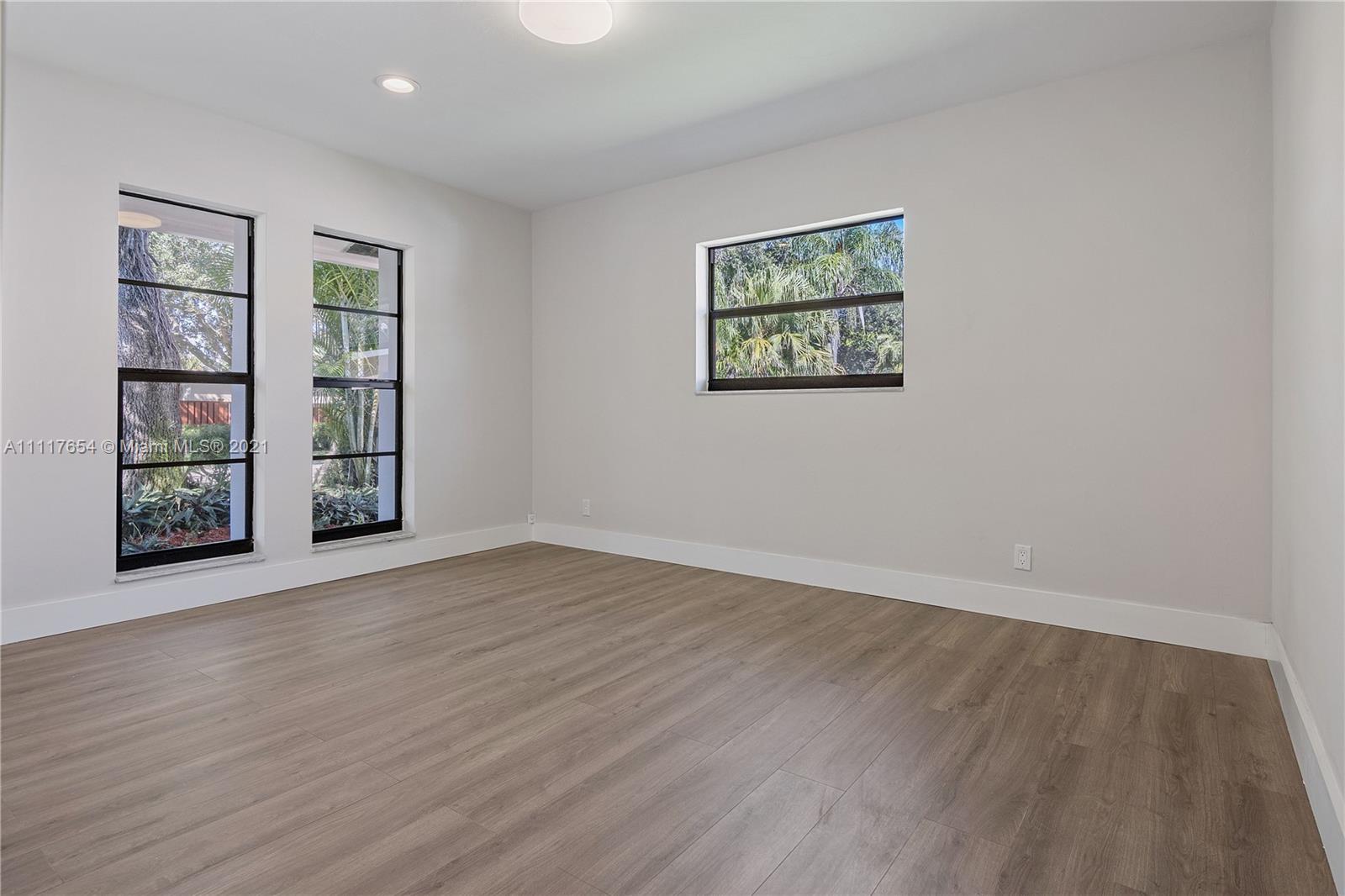 1960 Southwest 51st Terrace Plantation, FL 33317 - Photo 22 of 35 a view of an empty room with window and wooden floor