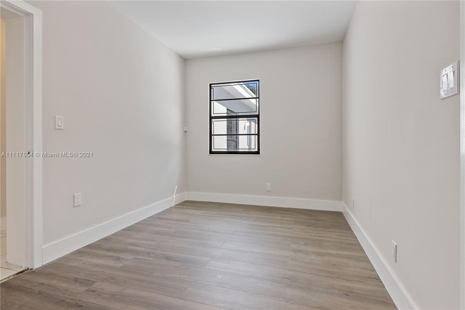 1960 Southwest 51st Terrace Plantation, FL 33317 - Photo 24 of 35 wooden floor in an empty room with a window