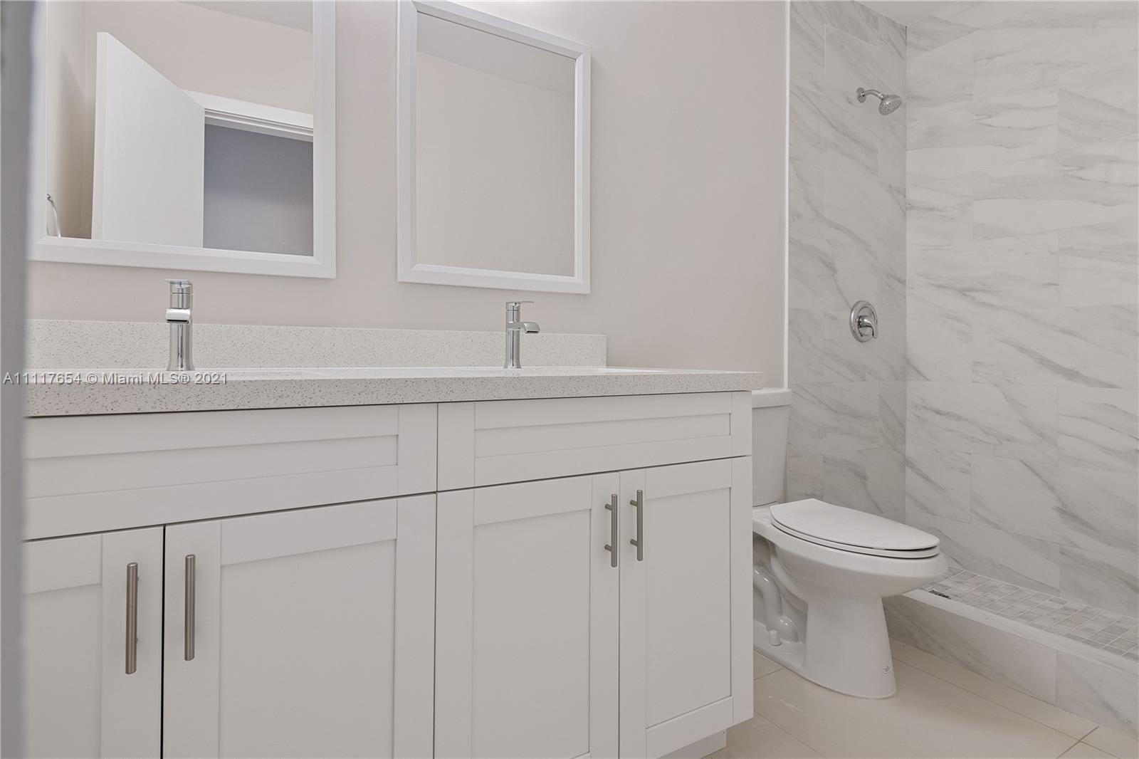 1960 Southwest 51st Terrace Plantation, FL 33317 - Photo 26 of 35 a bathroom with a sink toilet and a mirror