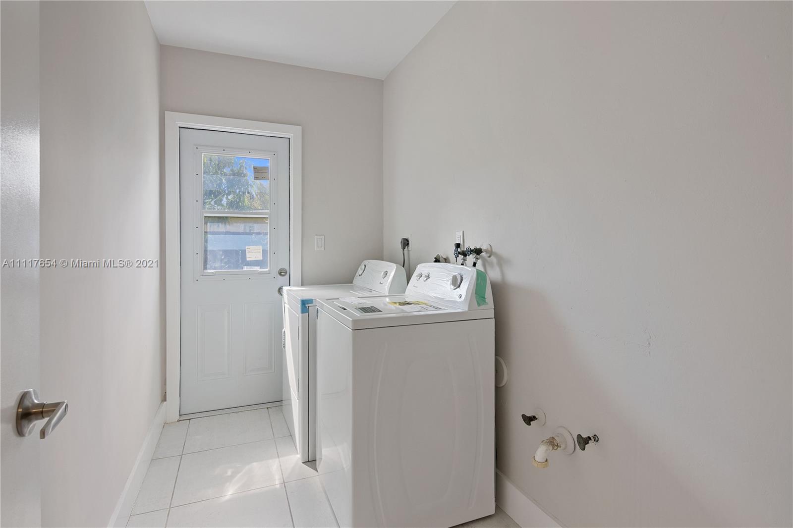 1960 Southwest 51st Terrace Plantation, FL 33317 - Photo 27 of 35 a utility room with dryer and washer