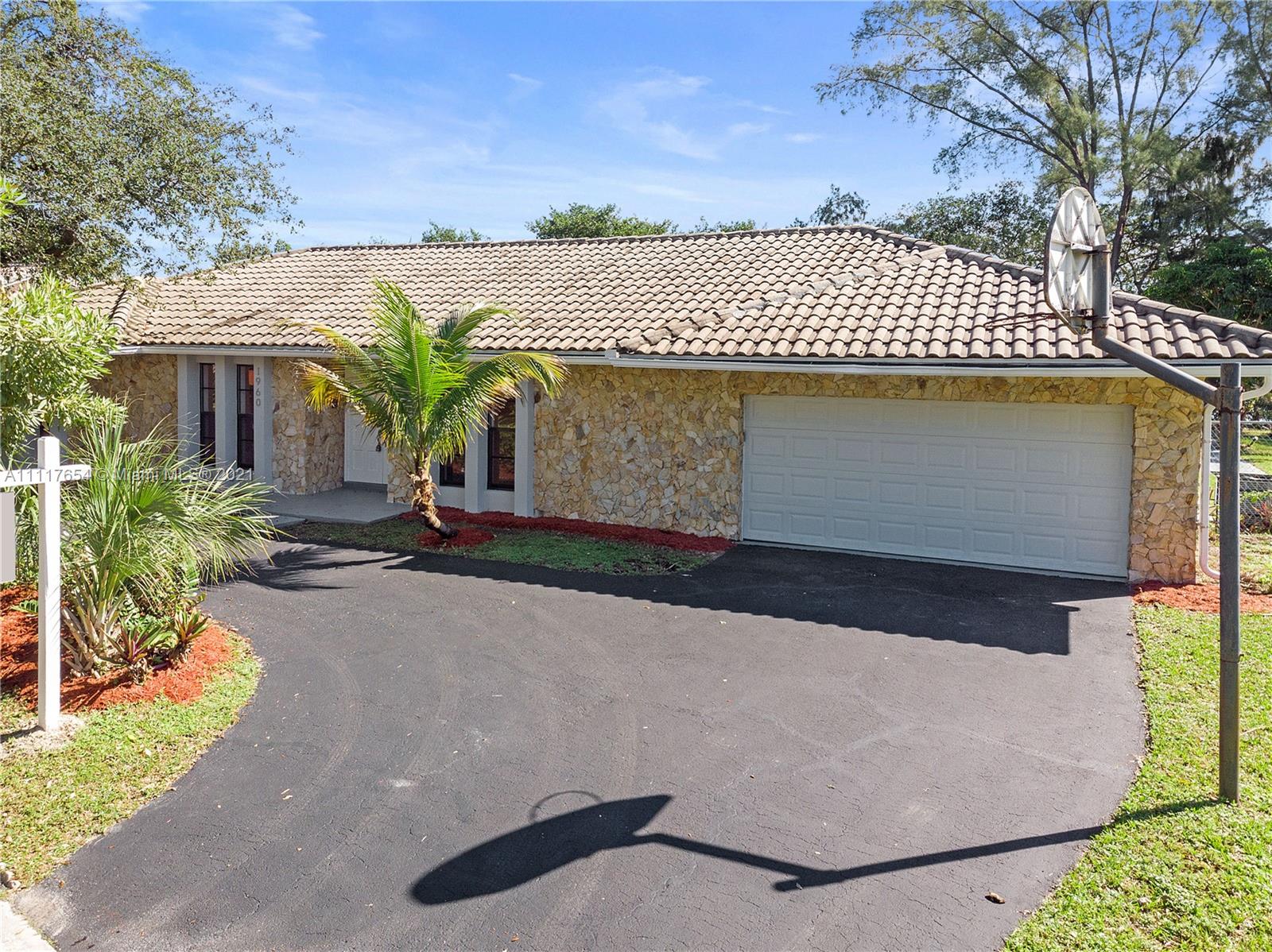 1960 Southwest 51st Terrace Plantation, FL 33317 - Photo 3 of 35 a front view of a house with a yard