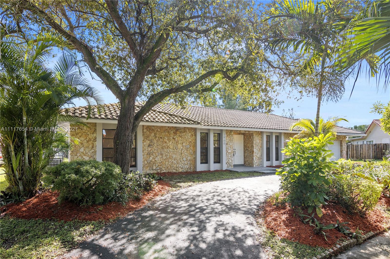 1960 Southwest 51st Terrace Plantation, FL 33317 - Photo 5 of 35 a front view of a house with a garden