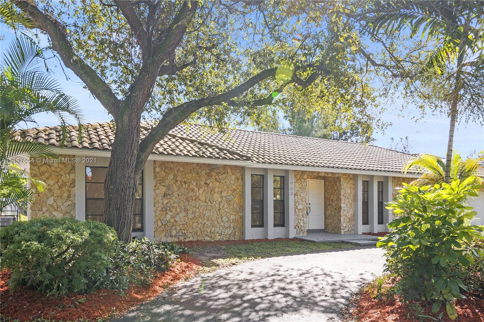 1960 Southwest 51st Terrace Plantation, FL 33317 - Photo 6 of 35 a front view of a house with garden