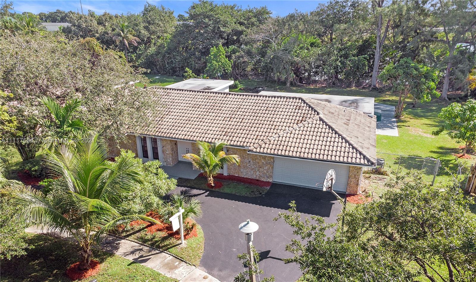1960 Southwest 51st Terrace Plantation, FL 33317 - Photo 7 of 35 a aerial view of a house with a yard and potted plants