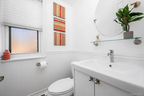 a bathroom with a sink a mirror and a toilet