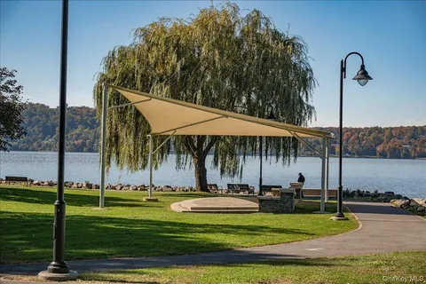 a view of a patio with table and chairs and floor to ceiling window