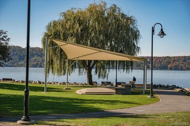 a view of a patio with table and chairs and floor to ceiling window