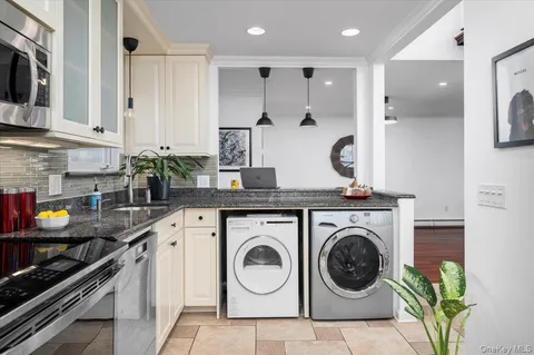 a kitchen with stainless steel appliances granite countertop a sink a stove and cabinets