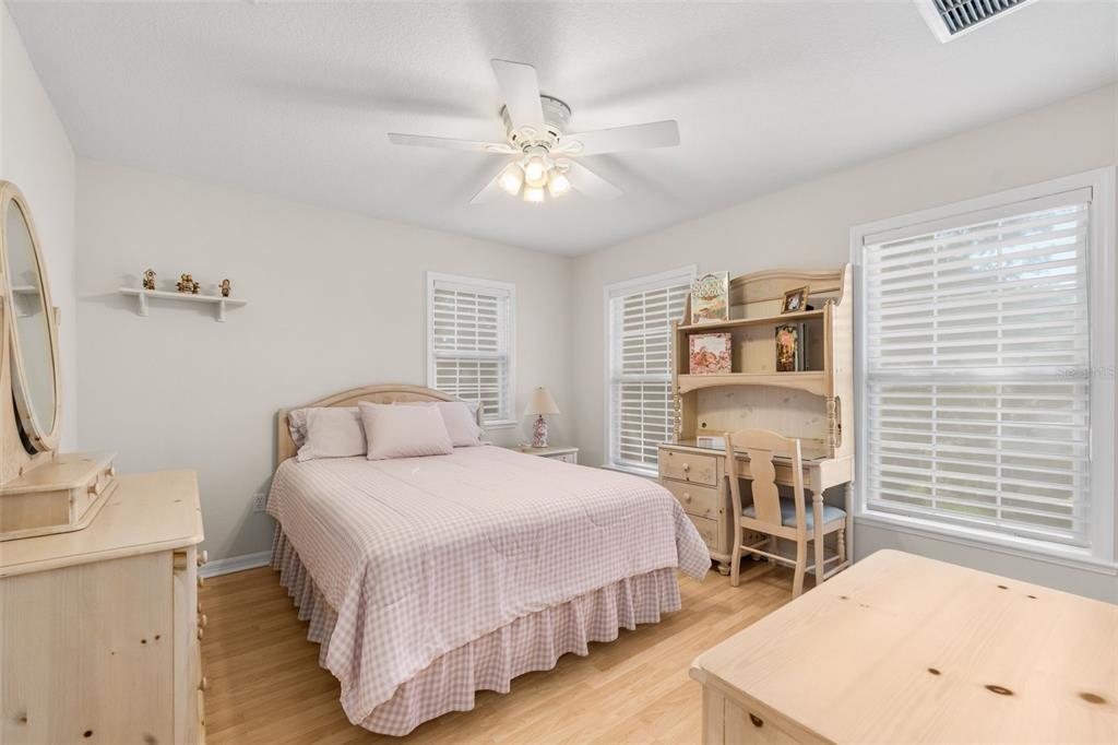 7418 White Oaks Road Alachua, FL 32615 - Photo 28 of 46 a bedroom with a bed and a table in it