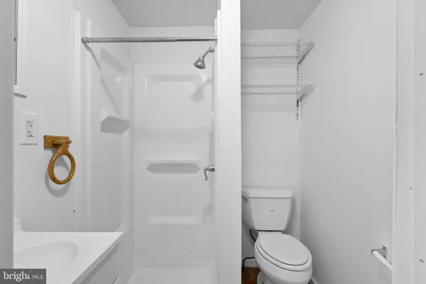 a bathroom with a shower toilet and sink