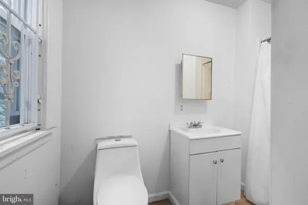 a bathroom with a toilet a sink and a mirror
