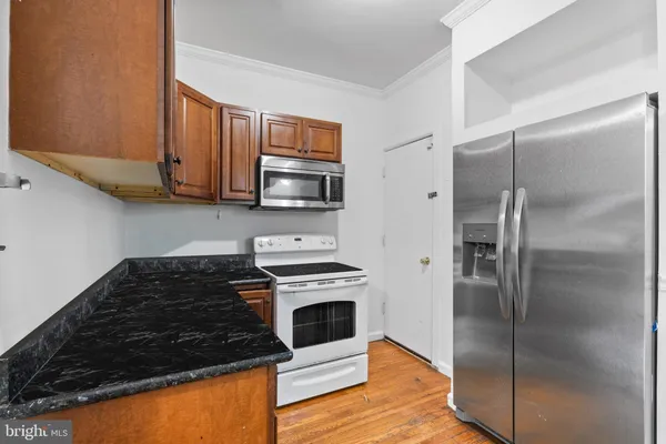 a kitchen with a refrigerator stove and microwave