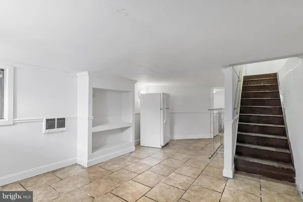 a view of a room with white walls and tiles