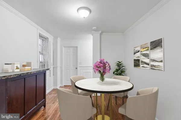 a view of a dining room with a table and chairs